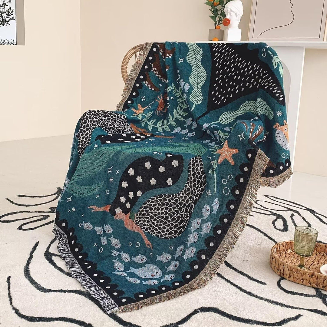 VibeCore Swimming Mermaids Woven Blanket as a chair cover, showcasing an enchanting mermaid design and soft 100% combed cotton texture.