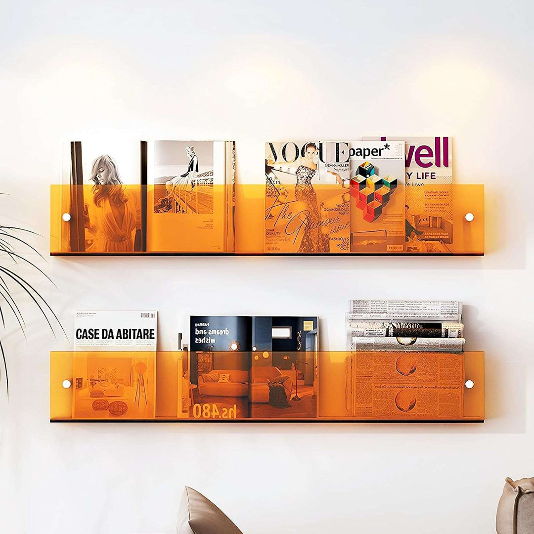 VibeCore Acrylic Wall Mounted Floating Magazine Shelf in orange, featuring magazines neatly displayed inside, adding a pop of color and modern style to any space.
