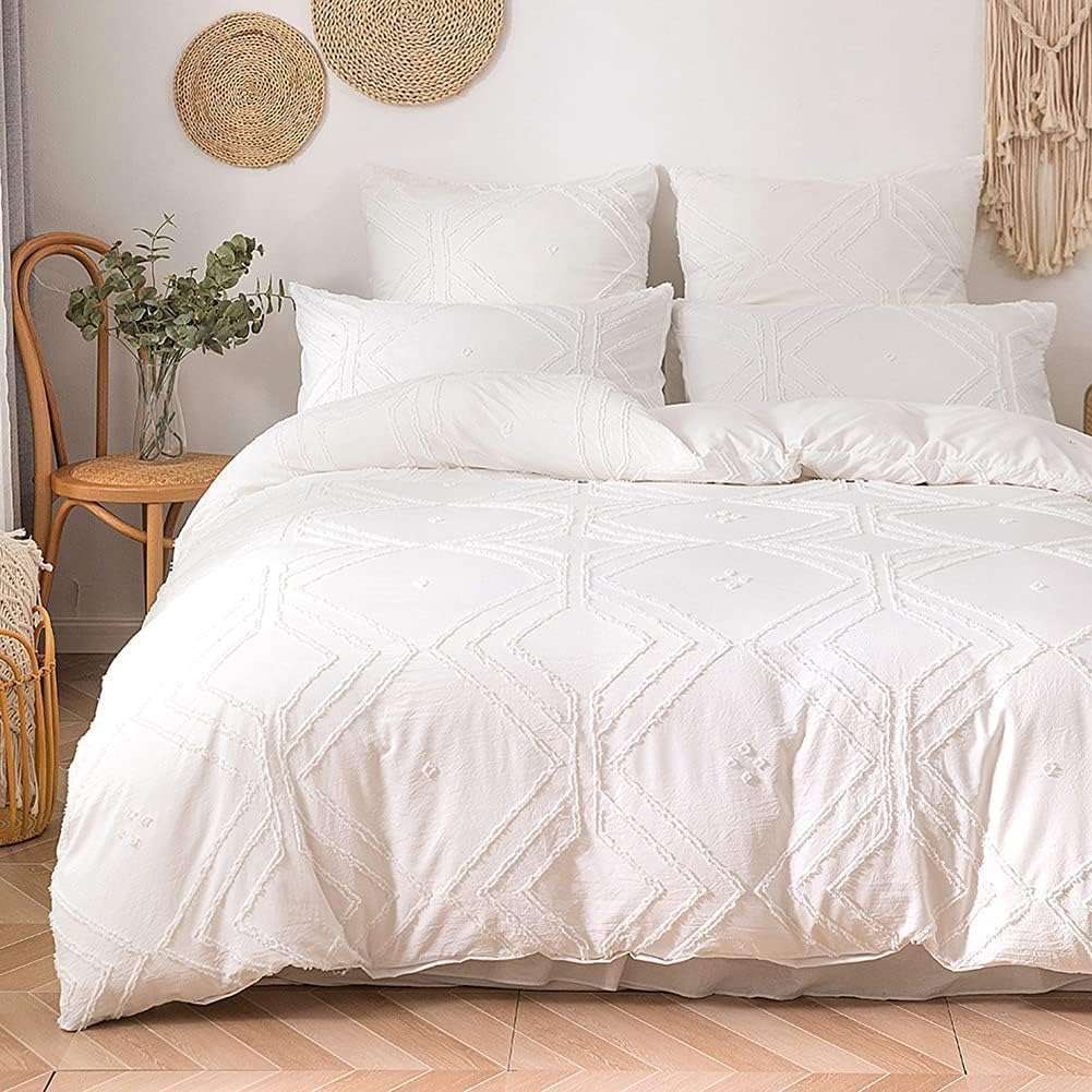 Close-up aerial view of the VibeCore Aesthetic Free Spirit Tufted Duvet Cover Set in white, highlighting the textured tufted design. The soft, plush pattern creates a cozy, inviting vibe with a modern boho feel, adding a touch of elegance and comfort to your bedroom or dorm.