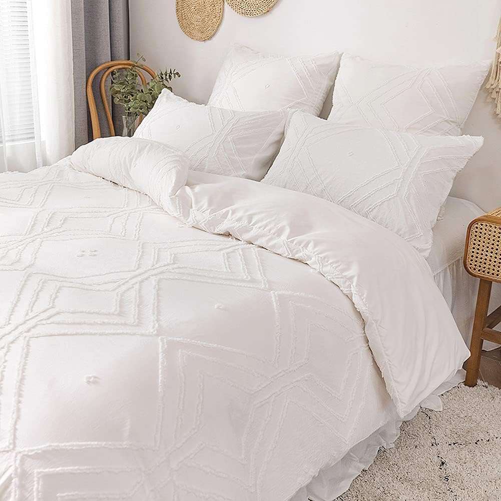 Side view of the VibeCore Aesthetic Free Spirit Tufted Duvet Cover Set in white, emphasizing the plush tufted texture and elegant design. The set features soft, breathable fabric that adds a boho-chic vibe to your bedroom, combining comfort and style.