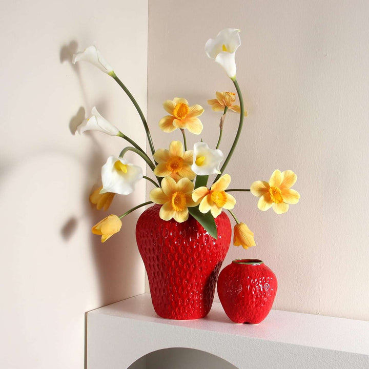 VibeCore Cartoon Strawberry Ceramic Vase in red, featuring both small and large sizes, filled with colorful flowers, offering a fun and vibrant addition to any room with its whimsical strawberry design.