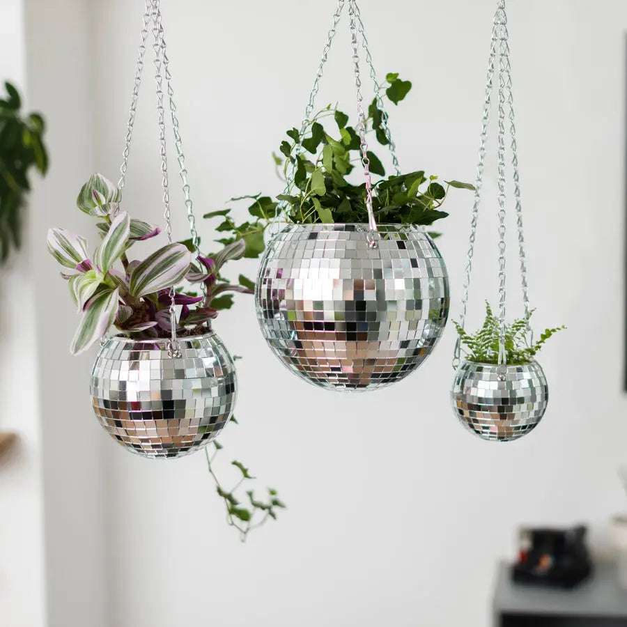 VibeCore Disco Ball Planter in 3 sizes, hanging with a shiny, reflective mirror-ball surface. This unique planter combines fun, retro design with functionality, offering a playful, disco-inspired look for your plants. Whether displayed in your living room, bedroom, or office, these hanging planters add a touch of sparkle and elevate your decor with their eye-catching design.