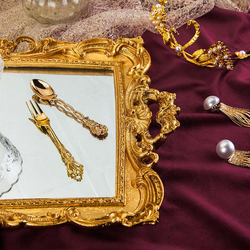 Close-up of the elegant gold handle detailing on this luxurious mirror tray. Features intricate gold accents and a reflective surface, adding sophistication and vintage charm to any space.