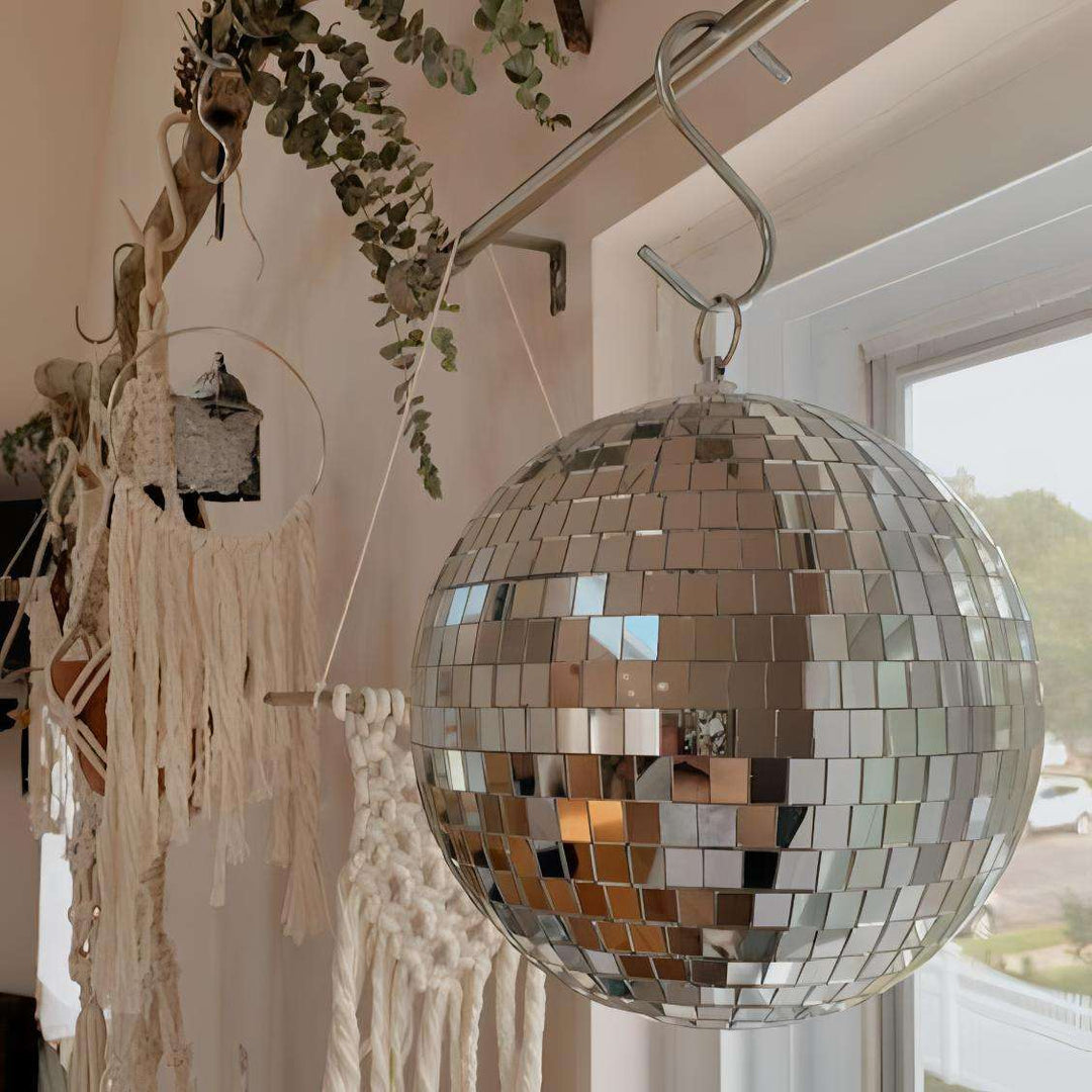 VibeCore Iconic Disco Ball—close-up view next to a window, reflecting light beautifully, creating a vibrant and sparkling atmosphere in your room.