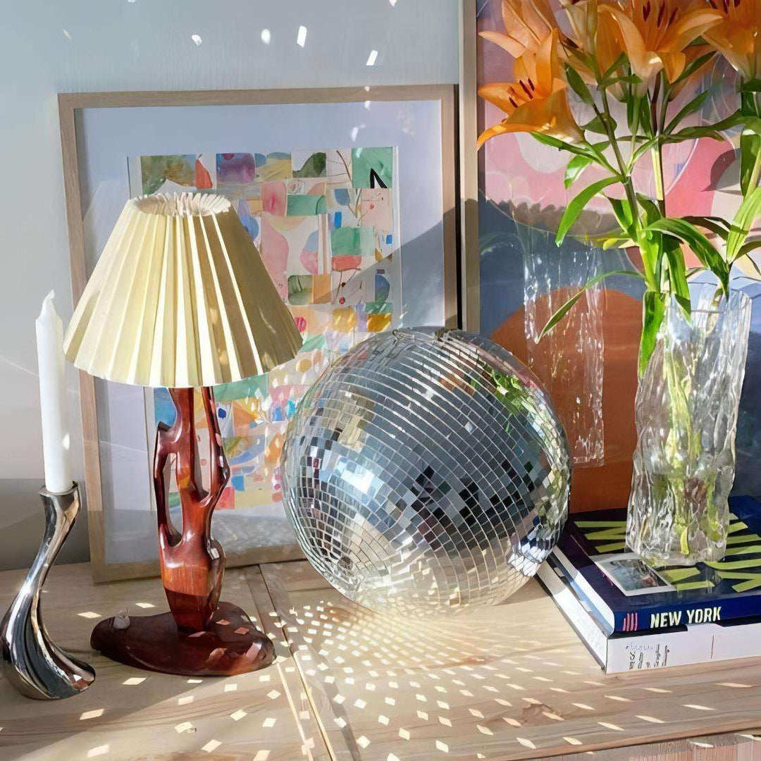 VibeCore Iconic Disco Ball placed on a living room dresser, reflecting light in all directions and adding sparkle to the space, creating an energetic and festive atmosphere.