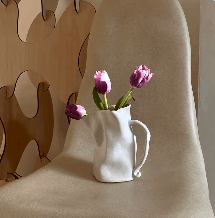 VibeCore Irregularly Folded Ceramic Vase in White with dried flowers, showcasing a sleek, sculptural design for modern, minimalist decor.