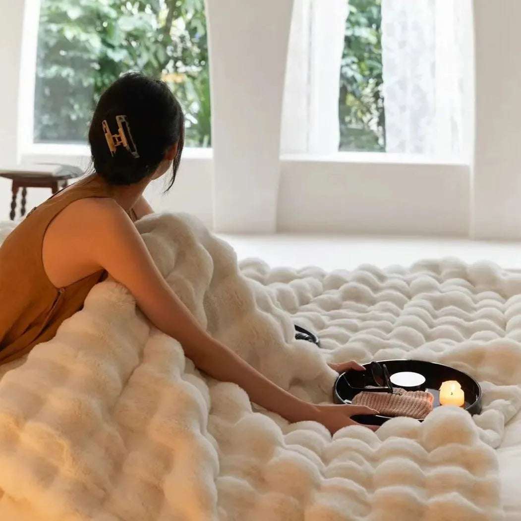 VibeCore Marshmallow Ultra Plush Blanket White Girl Cuddled In It In Bed, showing the thick and soft material.