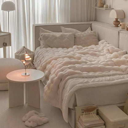 VibeCore Marshmallow Ultra Plush Blanket White On Bed Angled Close Up, showing the soft and aesthetic white blanket in a white room.