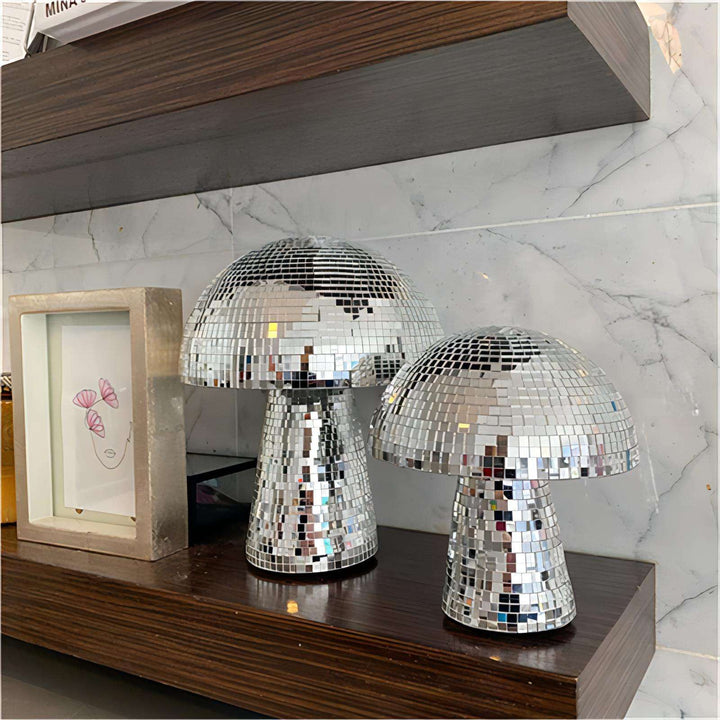 Two VibeCore Mushroom Disco Balls on a shelf, reflecting colorful light patterns and adding a fun, retro touch to the decor. These unique mushroom-shaped disco balls create a vibrant, eclectic vibe in any space.