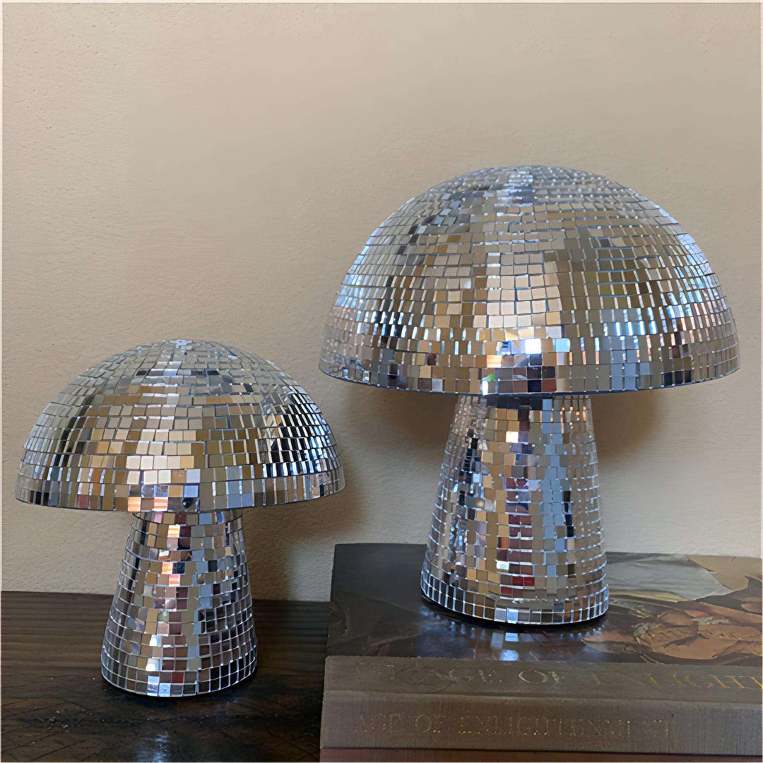 Two sizes of the VibeCore Mushroom Disco Ball displayed side by side, highlighting their unique mushroom shape and reflective surfaces that cast vibrant light patterns, perfect for adding a playful touch to any space.