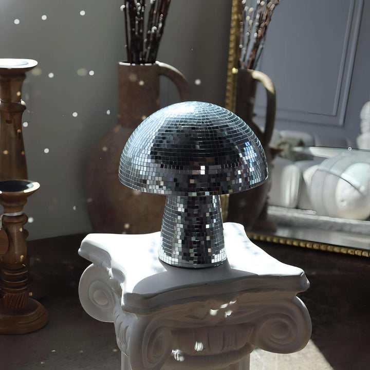 A VibeCore Mushroom Disco Ball placed on a side table, reflecting light and adding a playful, vibrant touch to the room's decor. Its unique mushroom shape creates a mesmerizing lighting effect, enhancing the ambiance of the space.