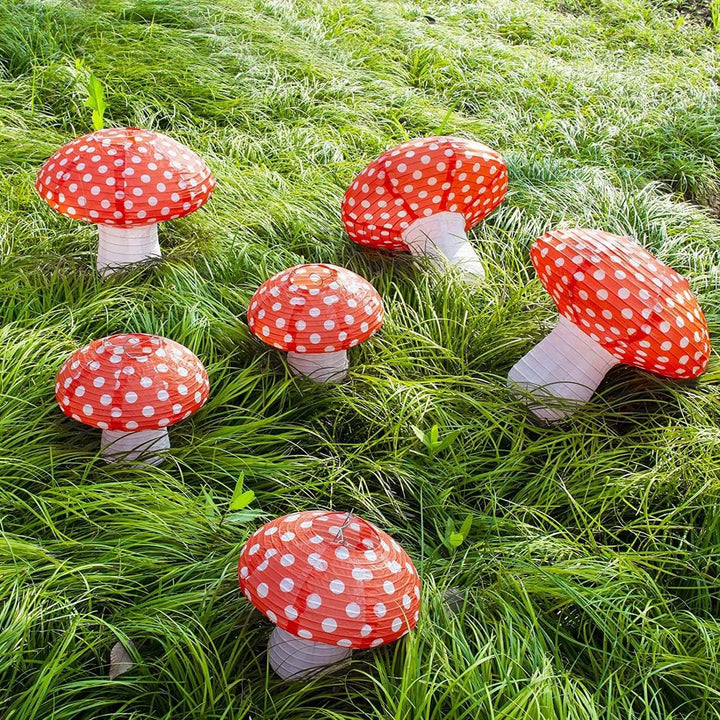 VibeCore Mushroom Lantern Pendants hanging in a bunch across a yard, creating a magical, whimsical atmosphere with soft lighting, perfect for outdoor decor and events.