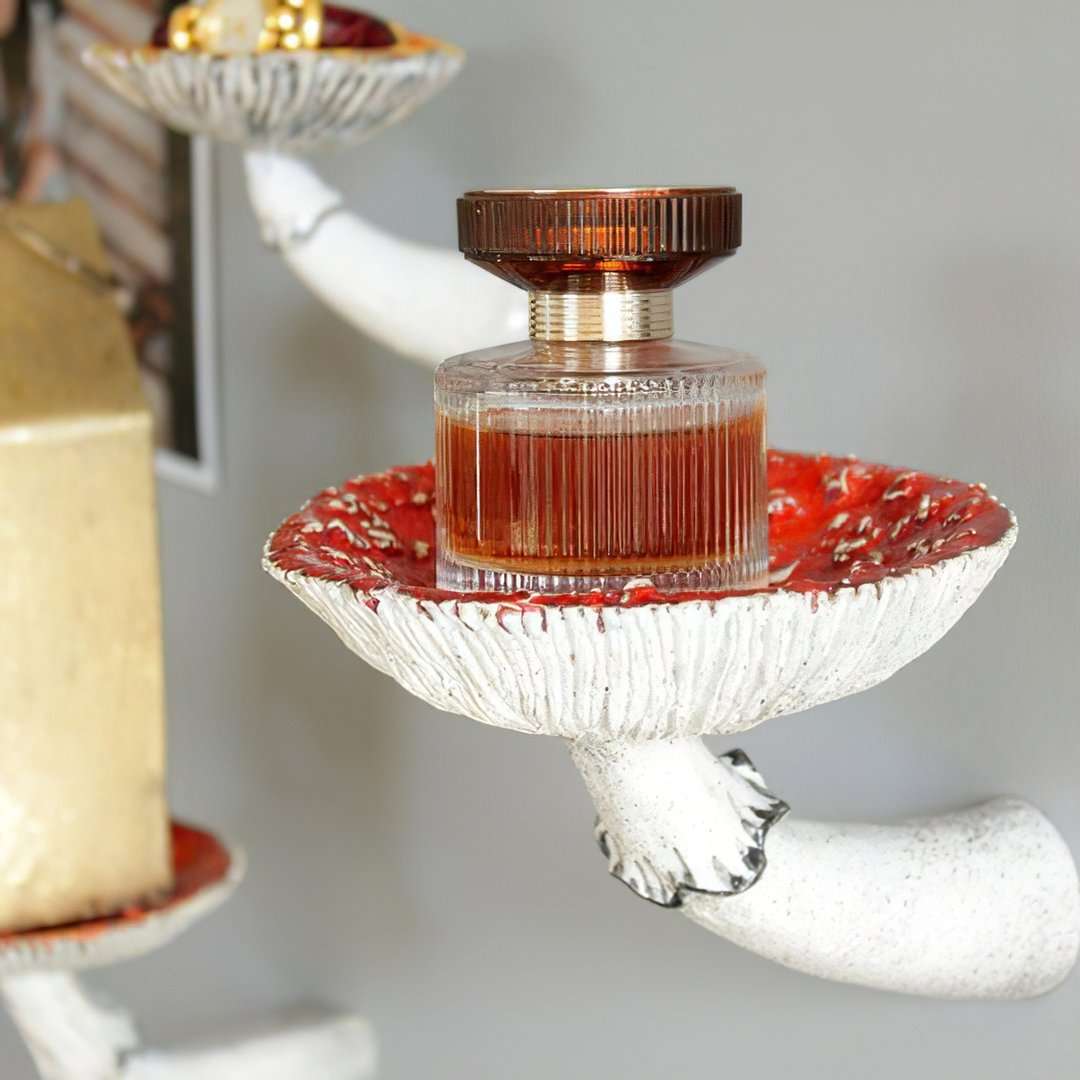 VibeCore Mushroom Wall Shelf holding a perfume bottle, showcasing its whimsical mushroom-shaped design, made of durable resin, perfect for displaying small decor items.