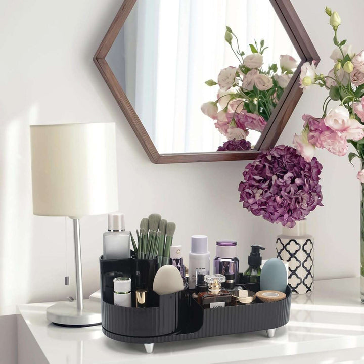 VibeCore Pleated Rotating Platform Makeup Organizer in black, positioned on a dresser. Featuring a sleek design and smooth 360° rotation for easy access to beauty essentials.