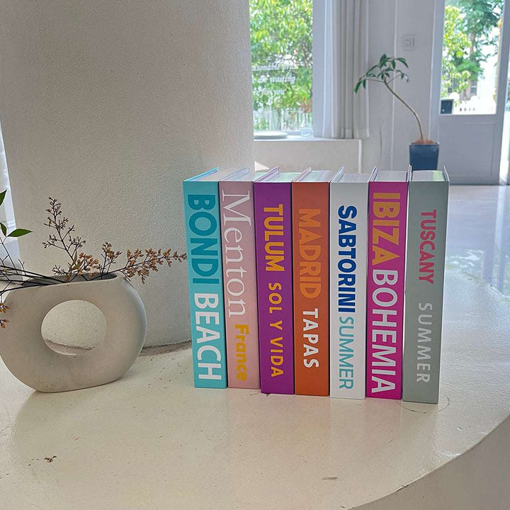 VibeCore Preppy Cities Fake Book Storage Box with city-themed design, placed on a table in a stylish preppy room. Ideal for organizing jewelry, stationery, or small items, adding a chic, functional touch to your decor.