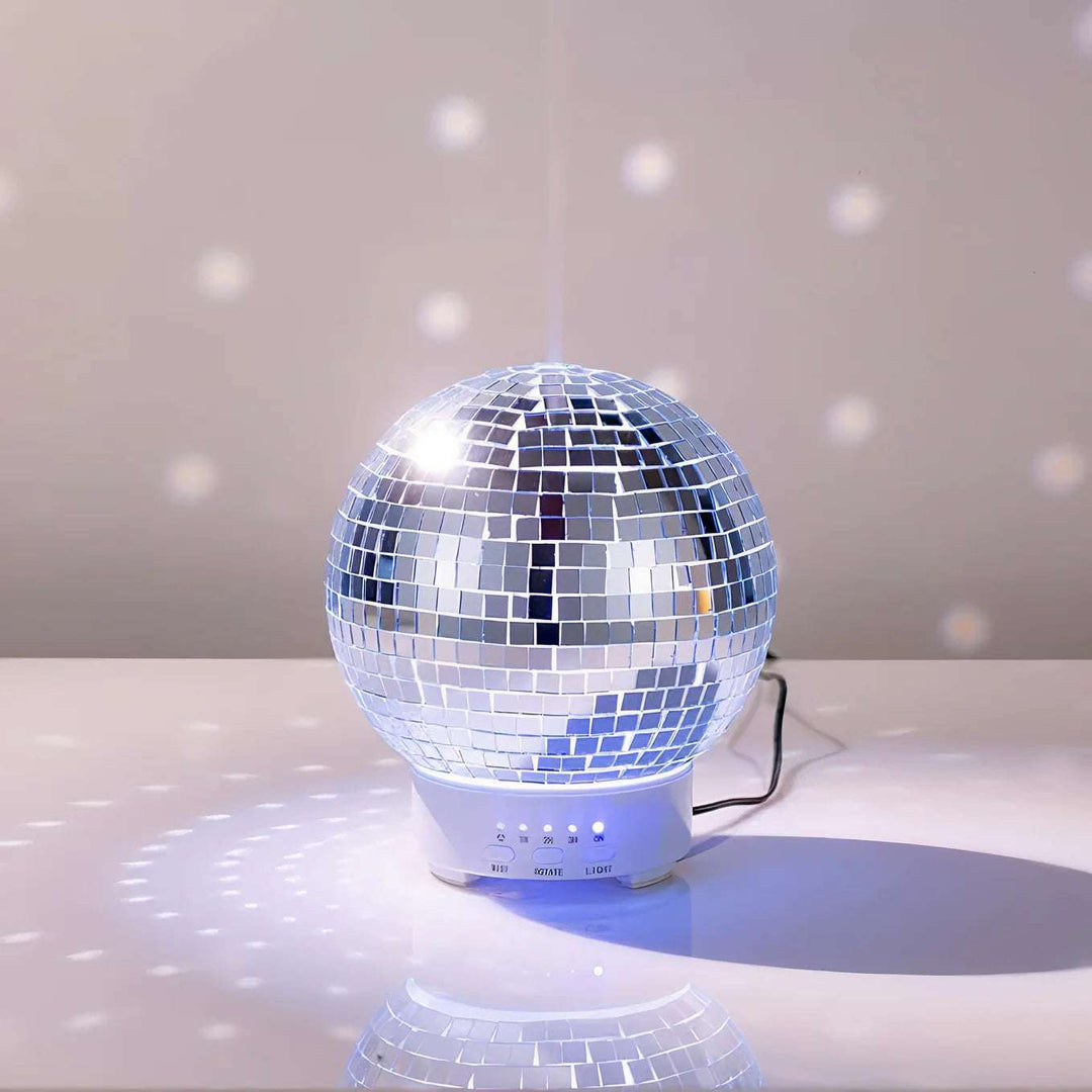 VibeCore Rotating Disco Ball Diffuser with mist gently diffusing, reflecting colorful light patterns across the room, adding a fun and relaxing atmosphere.