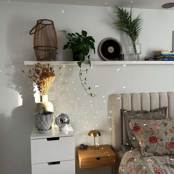 VibeCore Rotating Disco Ball Diffuser in a cozy bedroom, emitting colorful light patterns that create a fun, dynamic atmosphere while enhancing the room’s decor.
