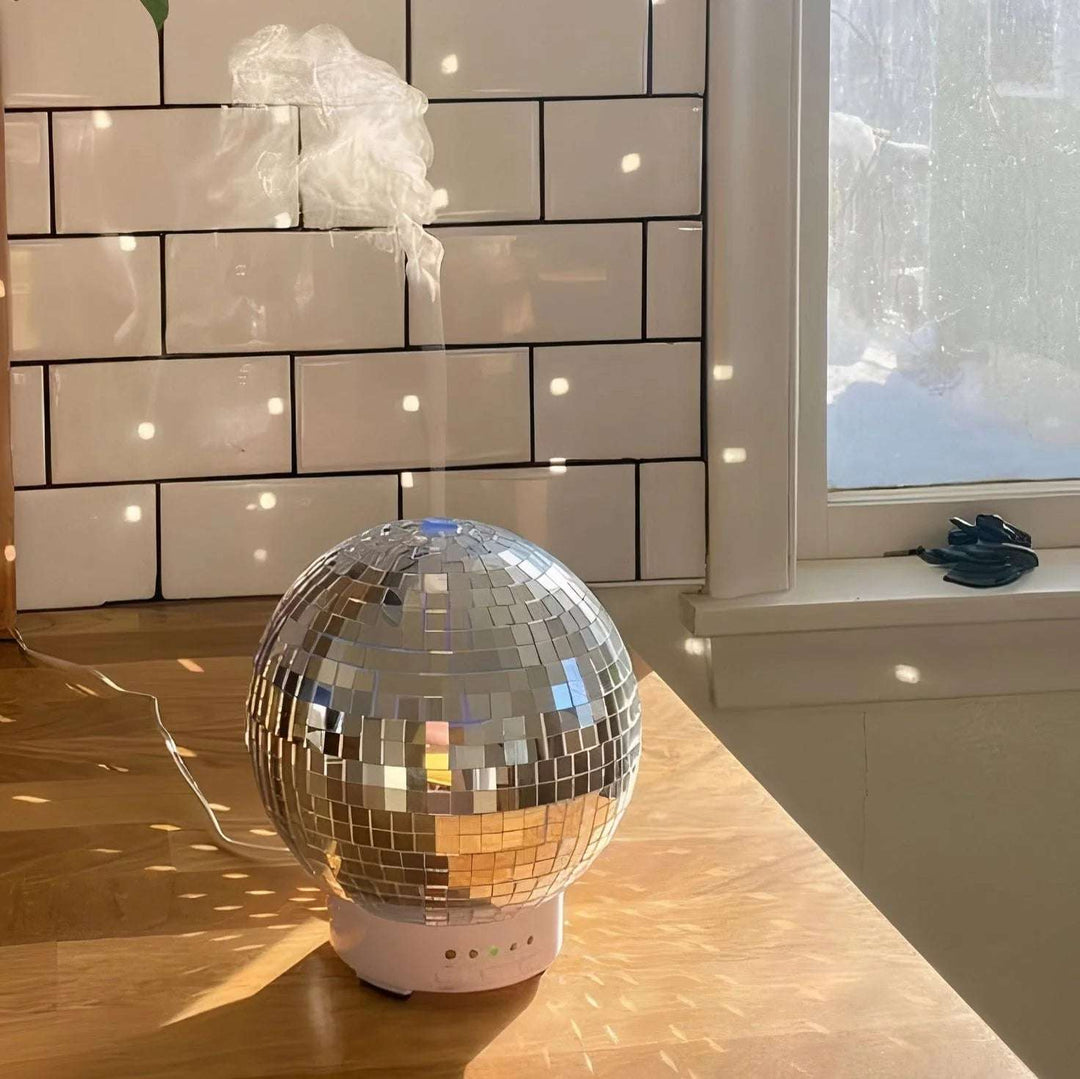 VibeCore Rotating Disco Ball Diffuser on kitchen counter, emitting vibrant light patterns and filling the room with a colorful ambiance, offering both aromatherapy and fun decor for a modern, eclectic space.