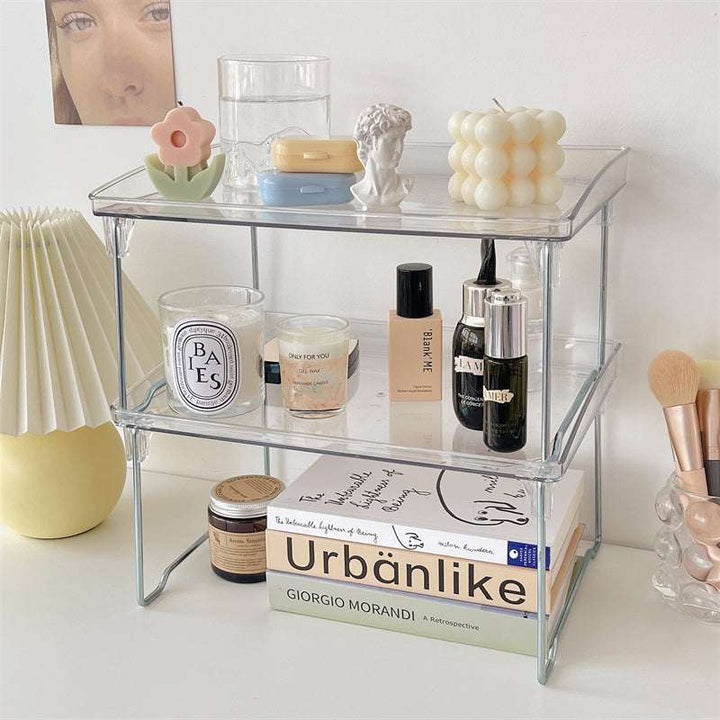 VibeCore Transparent Acrylic Foldable Shelf double shelf stack showcasing modern, minimalist design, with beauty and office products arranged for organized storage, space-saving, durable acrylic construction, versatile use in vanity, office, or bathroom.