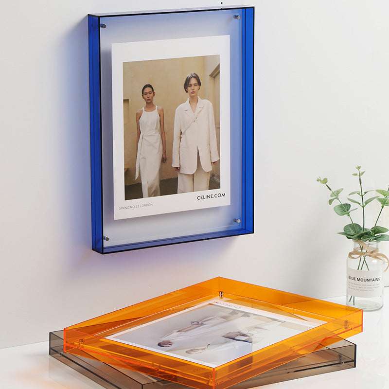 VibeCore Transparent Acrylic Photo Frame displayed on a wall, featuring a sleek, modern design. This clear picture frame enhances photos with a minimalist touch, seamlessly blending into any aesthetic. Available in multiple colors, it's perfect for contemporary, eclectic, and dopamine decor styles.