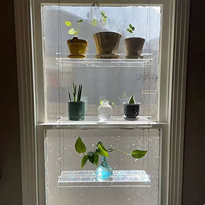 VibeCore Transparent Hanging Plant Shelf with 3 shelves in a home, showcasing a durable acrylic build, adjustable cords, and stylish display for plants and decor.