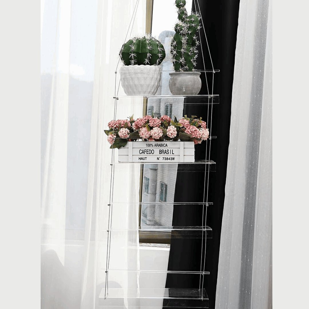 VibeCore Transparent Hanging Plant Shelf with 4 shelves in a home, featuring a sleek acrylic design, adjustable cords, and an elegant space-saving display for plants and decor.