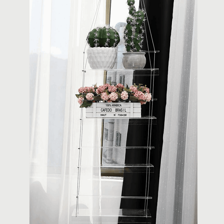 VibeCore Transparent Hanging Plant Shelf with 4 shelves in a home, featuring a sleek acrylic design, adjustable cords, and an elegant space-saving display for plants and decor.