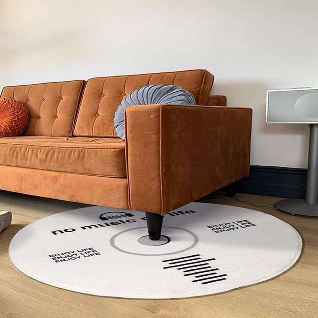 VibeCore White No Music Is Life Accent Rug under the couch, showcasing a minimalist CD design with bold typography, modern round rug, cozy and soft texture, music-inspired decor, non-slip backing, contemporary style, stylish accent piece for living room or bedroom, perfect for urban vibes.