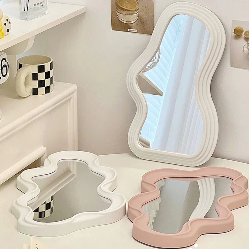 VibeCore Abstract Curve Wall Mirror Light Pink and White Ripple and White Curve On Table: Displaying both light pink and white mirrors with ripple and curve designs on a table, this setup brings a modern, artistic flair to your space, offering a striking contrast and dynamic aesthetic.