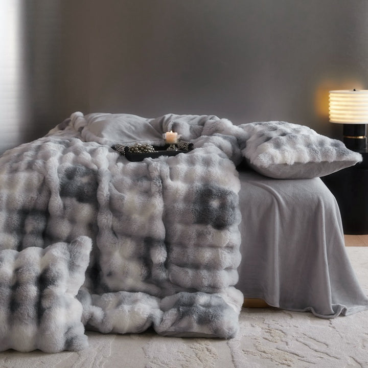 Side view of the 'Arctic Faux Fur Bedding Set' in Arctic Wolf, showcasing its soft, luxurious faux fur texture and cool, neutral gray and white tones. The bedding exudes a cozy, elegant vibe, perfect for adding comfort and style to any bedroom or dorm.