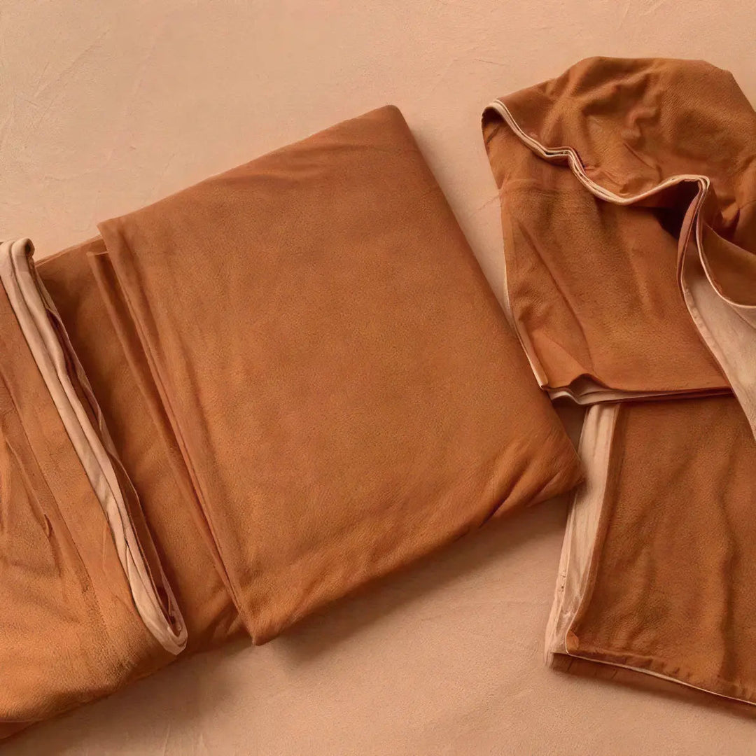 Close-up of the VibeCore Aesthetic Australian Cotton Duvet Cover Set in burnt orange sheet, emphasizing the soft, breathable texture of the premium Australian cotton fabric. The warm, earthy tone provides a cozy foundation for your bed, blending comfort and style to enhance your bedroom's aesthetic.