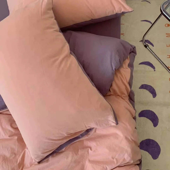 Close-up of the VibeCore Aesthetic Australian Cotton Duvet Cover Set in light pink, highlighting the soft, smooth texture of the premium Australian cotton fabric. The delicate pastel hue exudes tranquility and warmth, making it the perfect addition to create a cozy, inviting atmosphere in your bedroom.