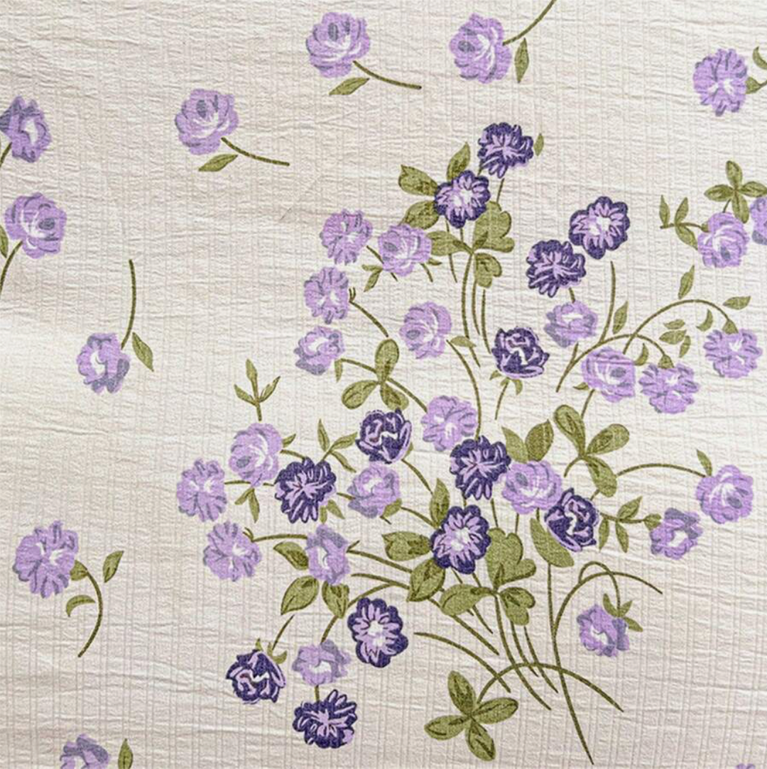 Close-up view of the VibeCore Aesthetic Blooming Lilacs Duvet Cover Set pattern, showcasing the intricate lilac floral design, adding a fresh and elegant touch to your bedroom or dorm aesthetic.