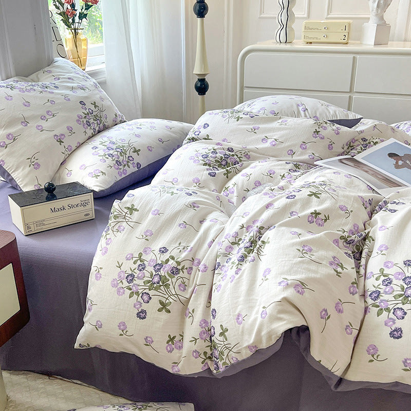 Side view of the VibeCore Aesthetic Blooming Lilacs Duvet Cover Set, highlighting the soft, lilac floral pattern and the textured fabric, creating a cozy and chic addition to your bedroom or dorm décor.