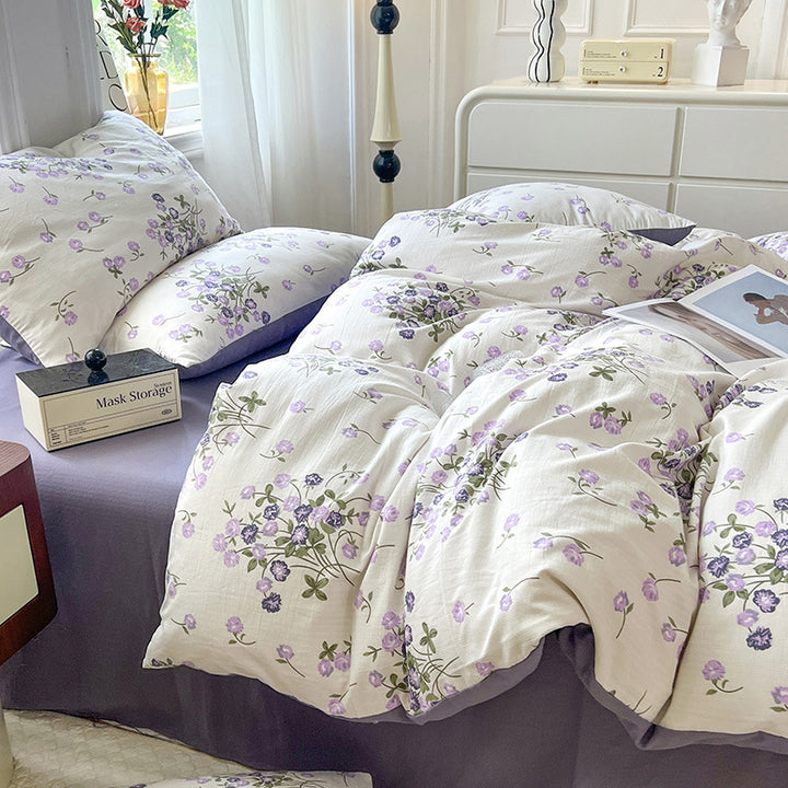 Side view of the VibeCore Aesthetic Blooming Lilacs Duvet Cover Set, highlighting the soft, lilac floral pattern and the textured fabric, creating a cozy and chic addition to your bedroom or dorm décor.