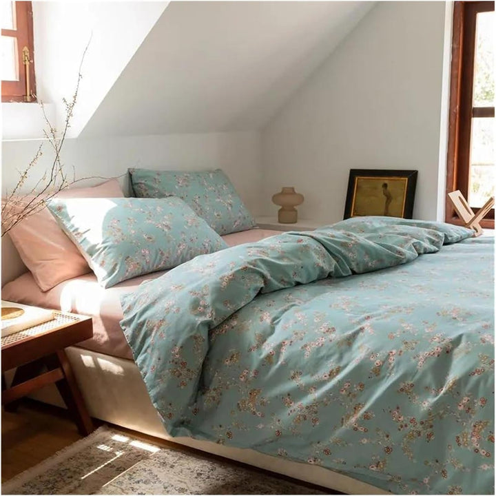 Side view of the VibeCore Aesthetic Blue Meadow Duvet Cover, highlighting its elegant floral pattern and soft, breathable cotton material, designed to bring a calming, nature-inspired atmosphere to your bedroom or dorm.