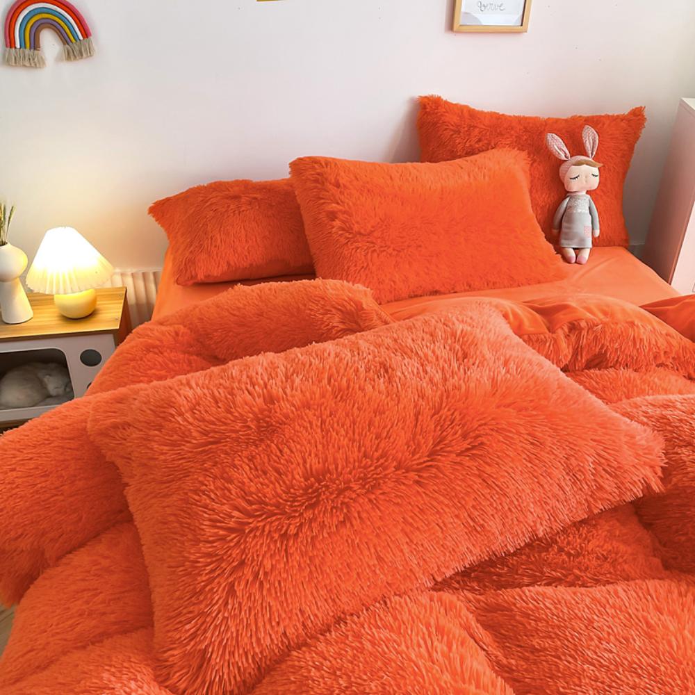 Close-up of the pillow cover and duvet from the VibeCore Cloud 9 Bedding Set in the color Orange, showcasing ultra-soft fleece fabric for exceptional comfort. This cozy, luxurious bedding set adds warmth and style to your bedroom or dorm, perfect for staying warm, relaxing, or enhancing your space.