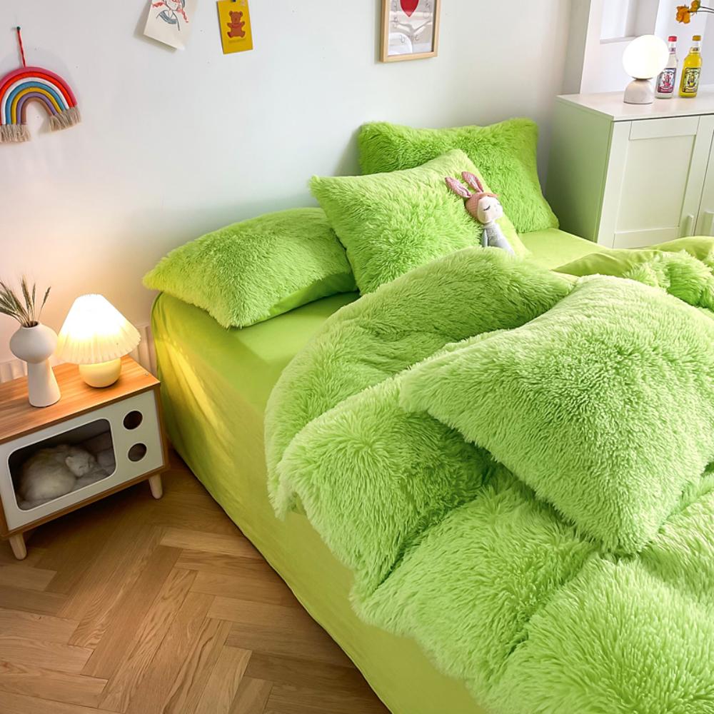 Left angle view of the VibeCore Cloud 9 Bedding Set in the color Green, featuring ultra-soft fleece fabric for unmatched comfort and warmth. This cozy bedding set adds a touch of luxury and style to your bedroom or dorm, perfect for relaxing and unwinding after a long, cold day.