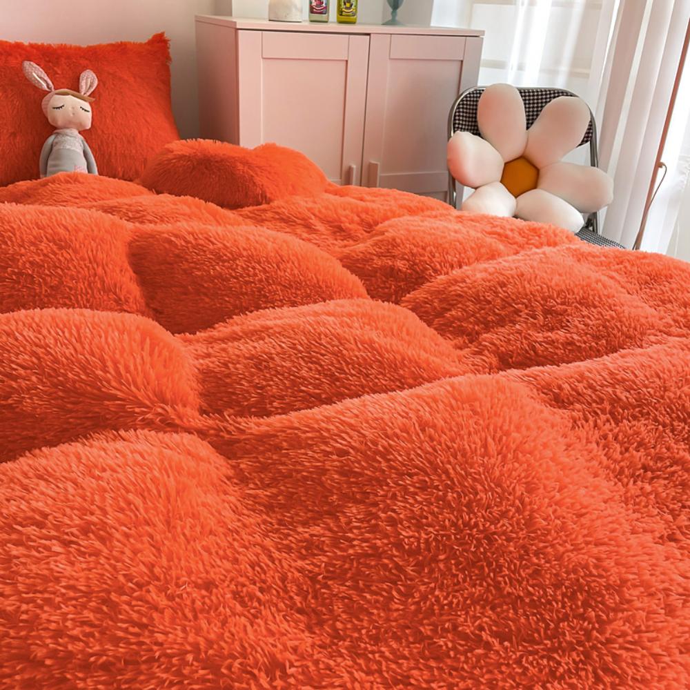 Ultra close-up of the plush material of the VibeCore Cloud 9 Plush Bedding Set in the colour Orange, showcasing its ultra-soft fleece fabric for superior comfort and cozy warmth. Perfect for creating a luxurious, comfortable sleep environment and adding stylish elegance to your bedroom or dorm.