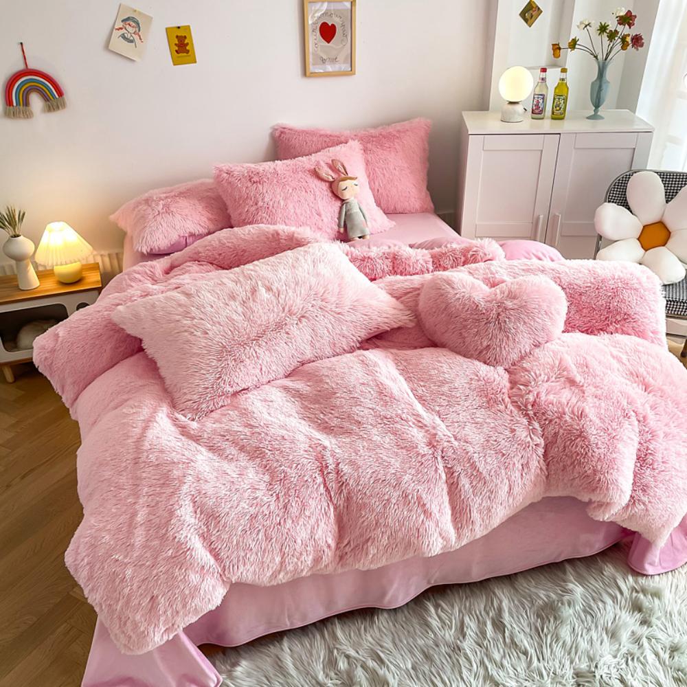 Left angle view of the VibeCore Cloud 9 Bedding Set in the color Light Pink, featuring ultra-soft fleece fabric for unmatched comfort and warmth. This cozy bedding set adds a touch of luxury and style to your bedroom or dorm, perfect for relaxing and unwinding after a long, cold day.