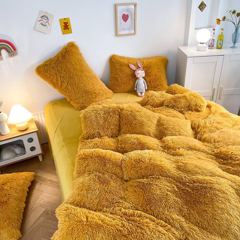 Left angle view of the VibeCore Cloud 9 Bedding Set in the color Mustard Yellow, featuring ultra-soft fleece fabric for unmatched comfort and warmth. This cozy bedding set adds a touch of luxury and style to your bedroom or dorm, perfect for relaxing and unwinding after a long, winter day.