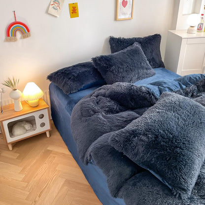 Left angle view of the VibeCore Cloud 9 Bedding Set in the color Navy Blue, featuring ultra-soft fleece fabric for unmatched comfort and warmth. This cozy bedding set adds a touch of luxury and style to your bedroom or dorm, perfect for relaxing and unwinding after a long, cold day.