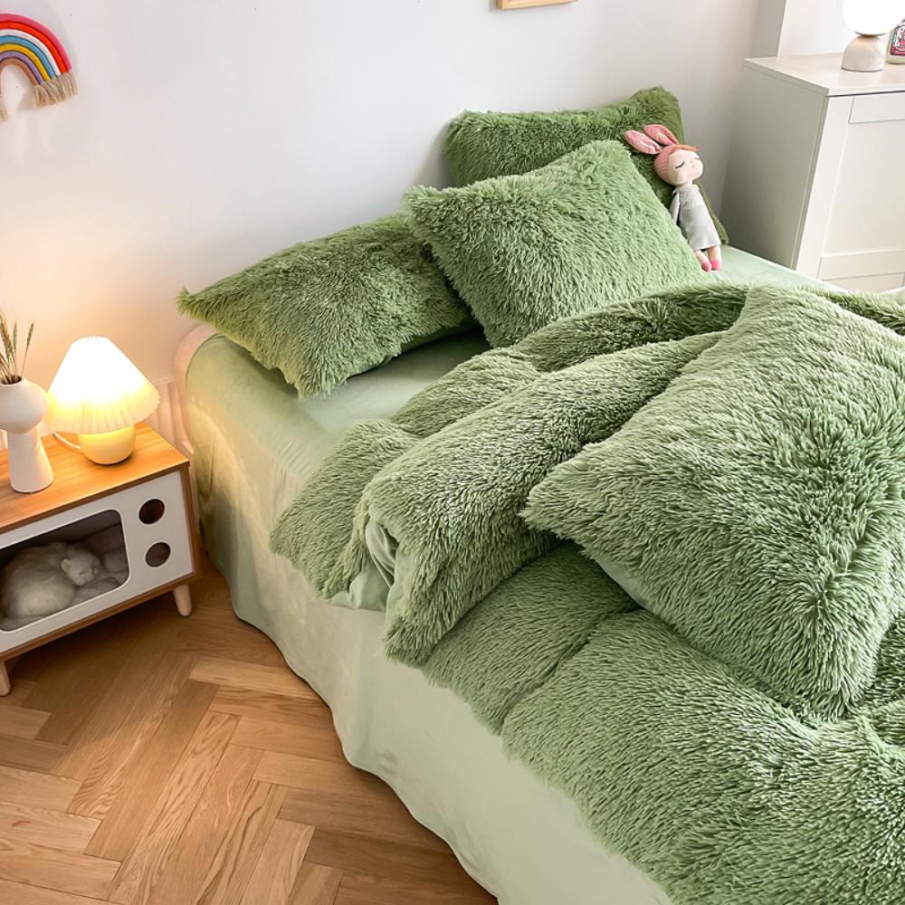 Left angle view of the VibeCore Cloud 9 Bedding Set in the color Sage, featuring ultra-soft fleece fabric for unmatched comfort and warmth. This cozy bedding set adds a touch of luxury and style to your bedroom or dorm, perfect for relaxing and unwinding after a long, cold day.