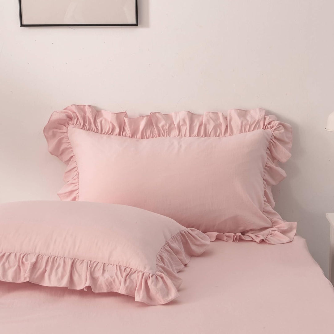Close-up of the pillowcases from the VibeCore Aesthetic Elegant Ruffles Duvet Cover Set in baby pink, showcasing the soft ruffle details and smooth, breathable fabric. A stylish and cozy accent to elevate any bedroom or dorm decor.