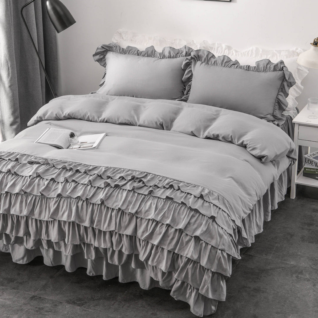 Aerial side view of the VibeCore Aesthetic Elegant Ruffles Duvet Cover Set in gray, featuring delicate ruffle details and soft, breathable fabric. A dreamy, modern addition to any bedroom or dorm, offering cozy comfort and an inviting aesthetic.