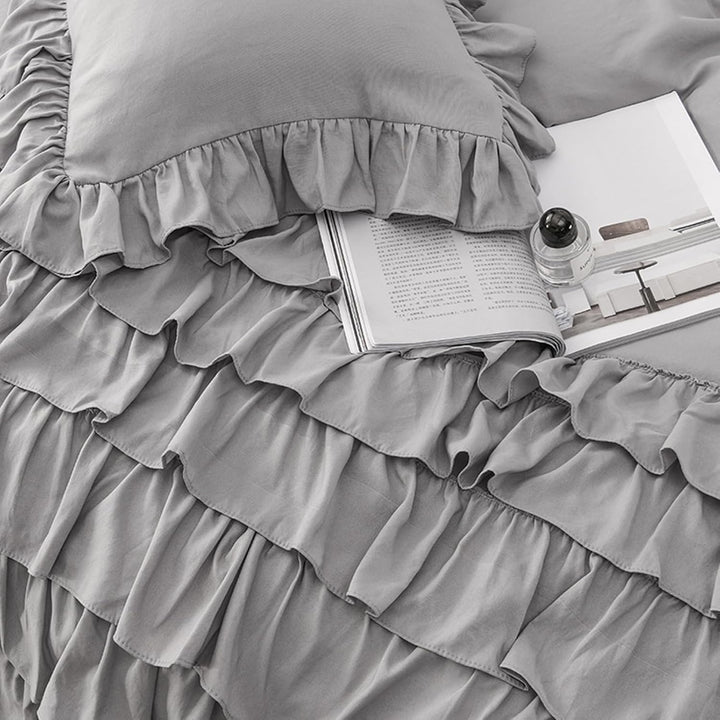 Close-up view of the VibeCore Aesthetic Elegant Ruffles Duvet Cover Set in gray, highlighting the soft ruffle details and the smooth, breathable fabric. The perfect blend of cozy comfort and chic, modern style for any bedroom or dorm.