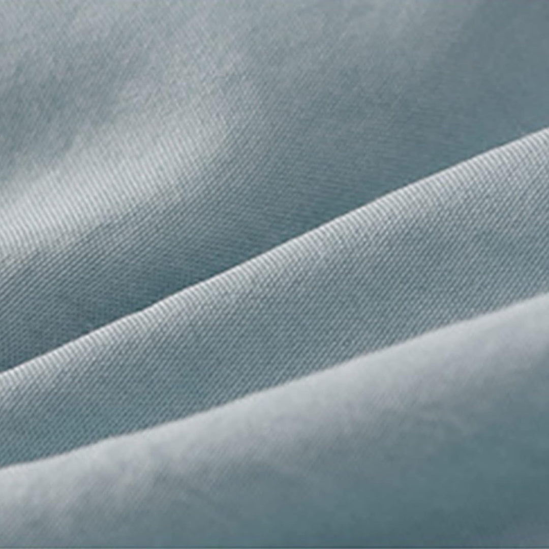 Close-up view of the material from the VibeCore Aesthetic Elegant Ruffles Duvet Cover Set in pastel blue, highlighting the soft, breathable fabric with delicate ruffle details. Made for ultimate comfort, this duvet set combines modern style with cozy, inviting texture.