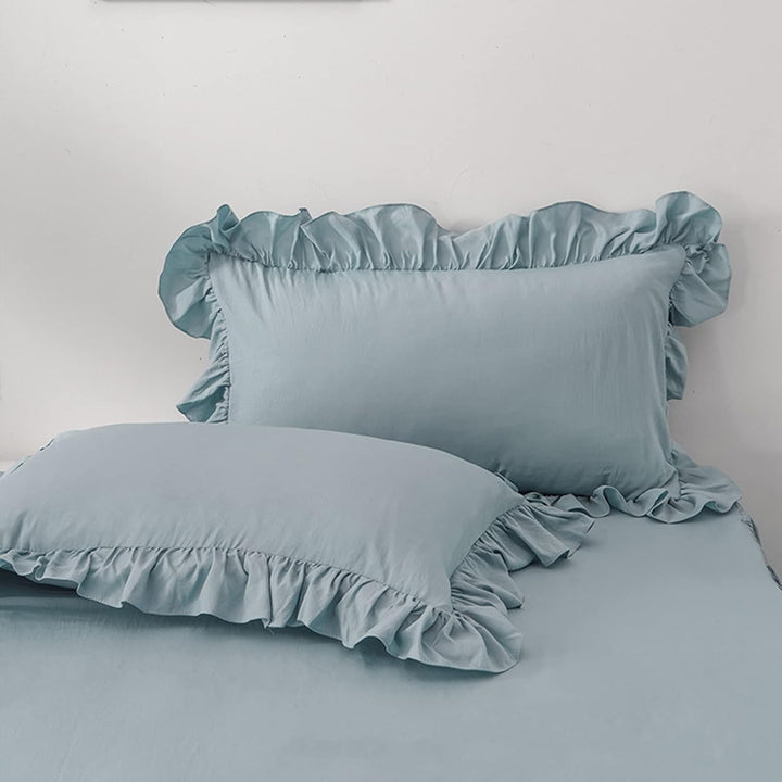 Close-up of the pillowcases from the VibeCore Aesthetic Elegant Ruffles Duvet Cover Set in pastel blue, showcasing the soft ruffle details and smooth, breathable fabric. A stylish and cozy accent to elevate any bedroom or dorm decor.