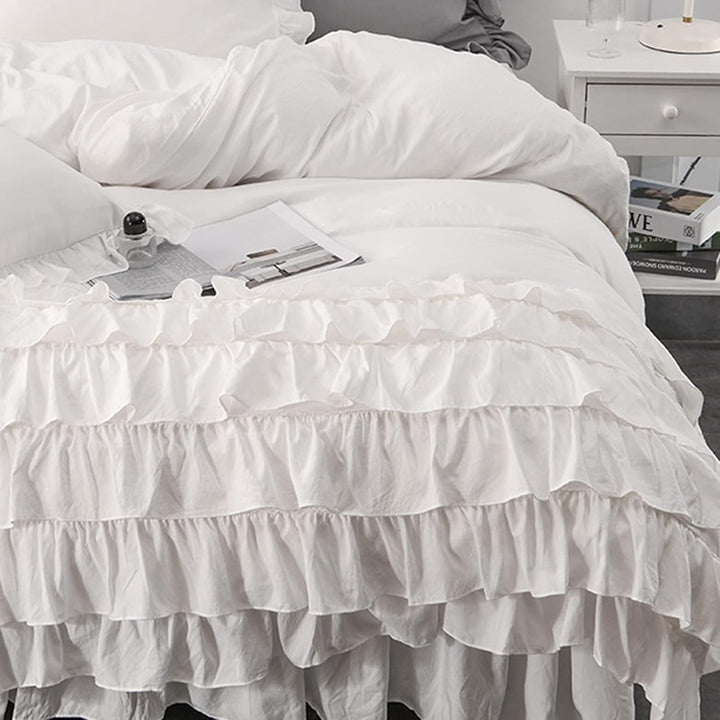 Close-up view of the VibeCore Aesthetic Elegant Ruffles Duvet Cover Set in white, highlighting the soft ruffle details and the smooth, breathable fabric. The perfect blend of cozy comfort and chic, modern style for any bedroom or dorm.