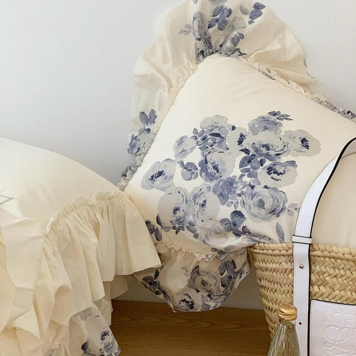 VibeCore Aesthetic Flower Ink French Ruffles Duvet Cover Set pillowcase arranged neatly in a woven basket, highlighting the delicate floral ink design and soft, ruffled edges for a charming, cozy look.